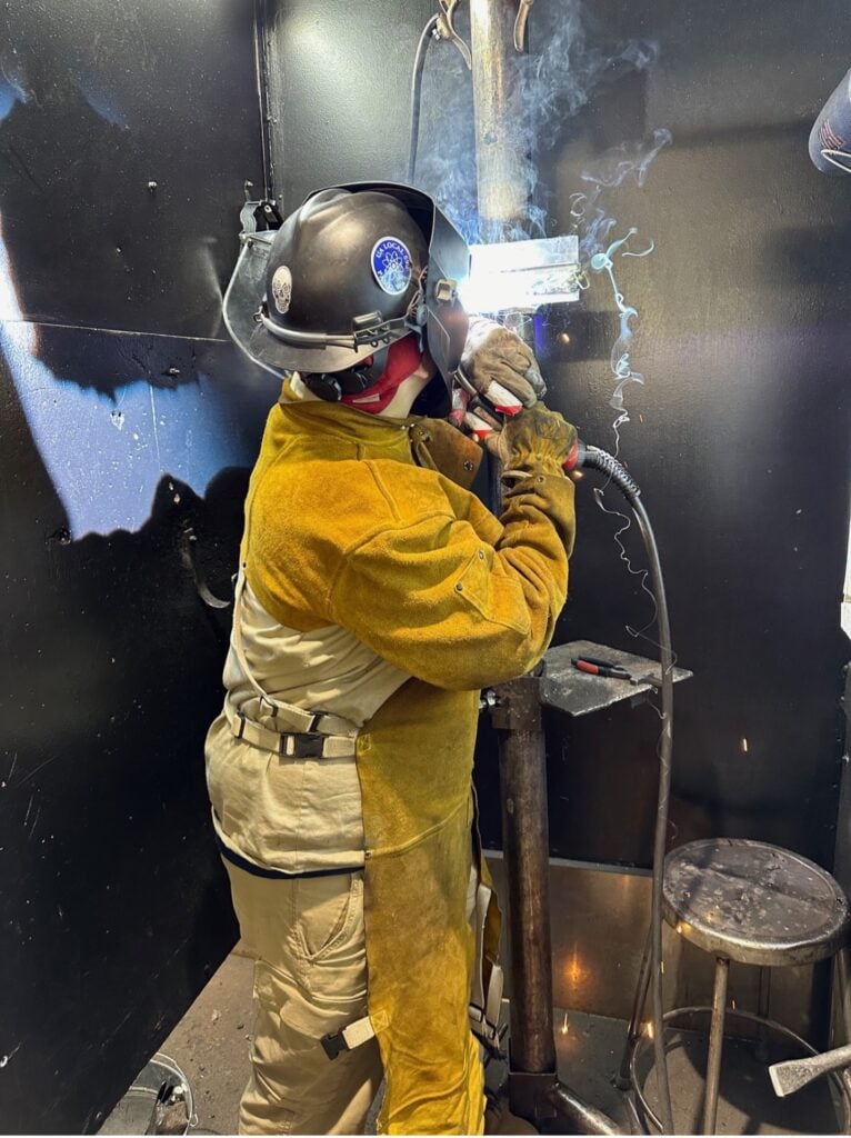 image of student welding