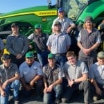 Group of WWCC students in front of a John Deere tractor